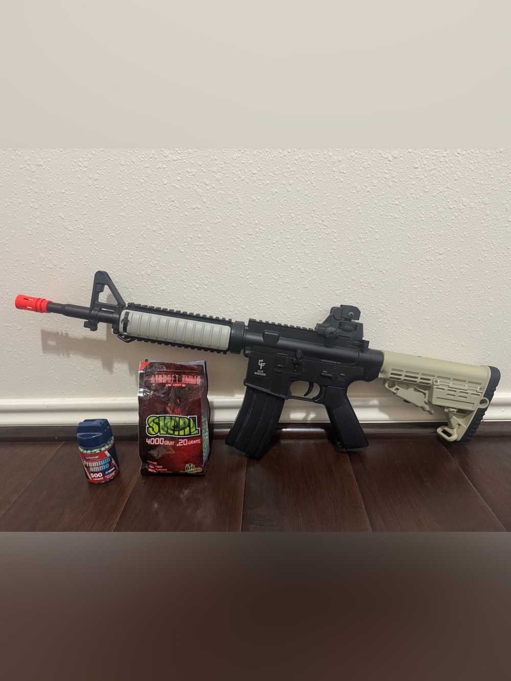 Black and Tan Airsoft M4-Style Rifle with Red Tip